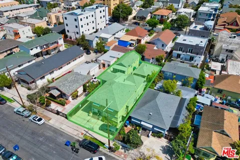 an aerial view of multiple houses with yard