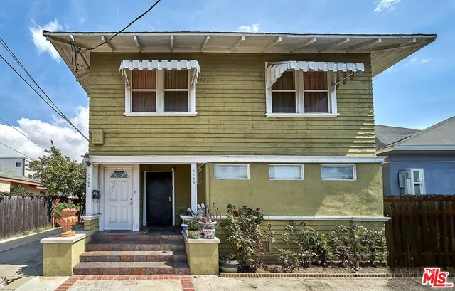 a view of a patio with table and chairs and potted plants