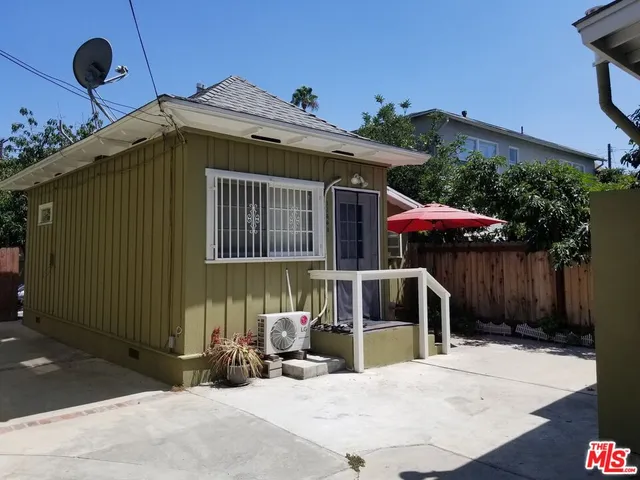 a front view of a house with porch and furniture
