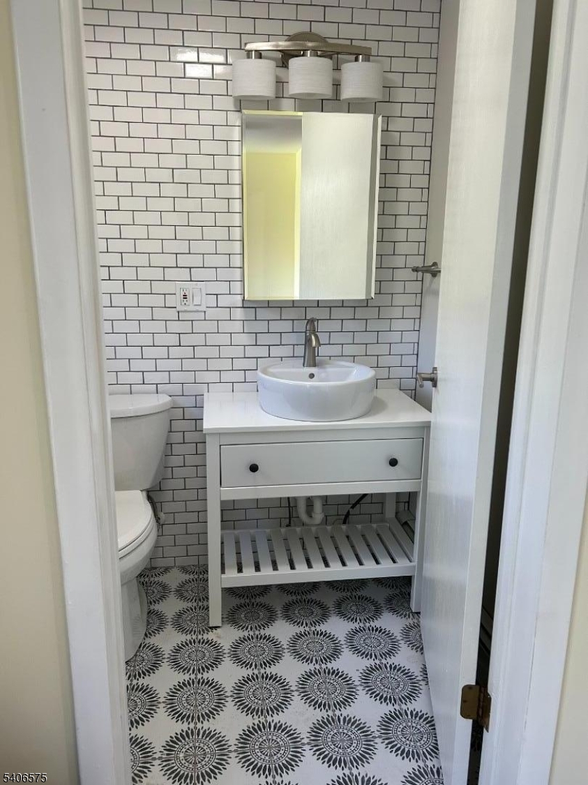 a bathroom with a sink a toilet and mirror