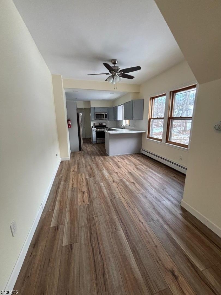 225 East Northfield Road Livingston, NJ 07039 - Photo 4 of 11 wooden floor in kitchen with window and wooden floor