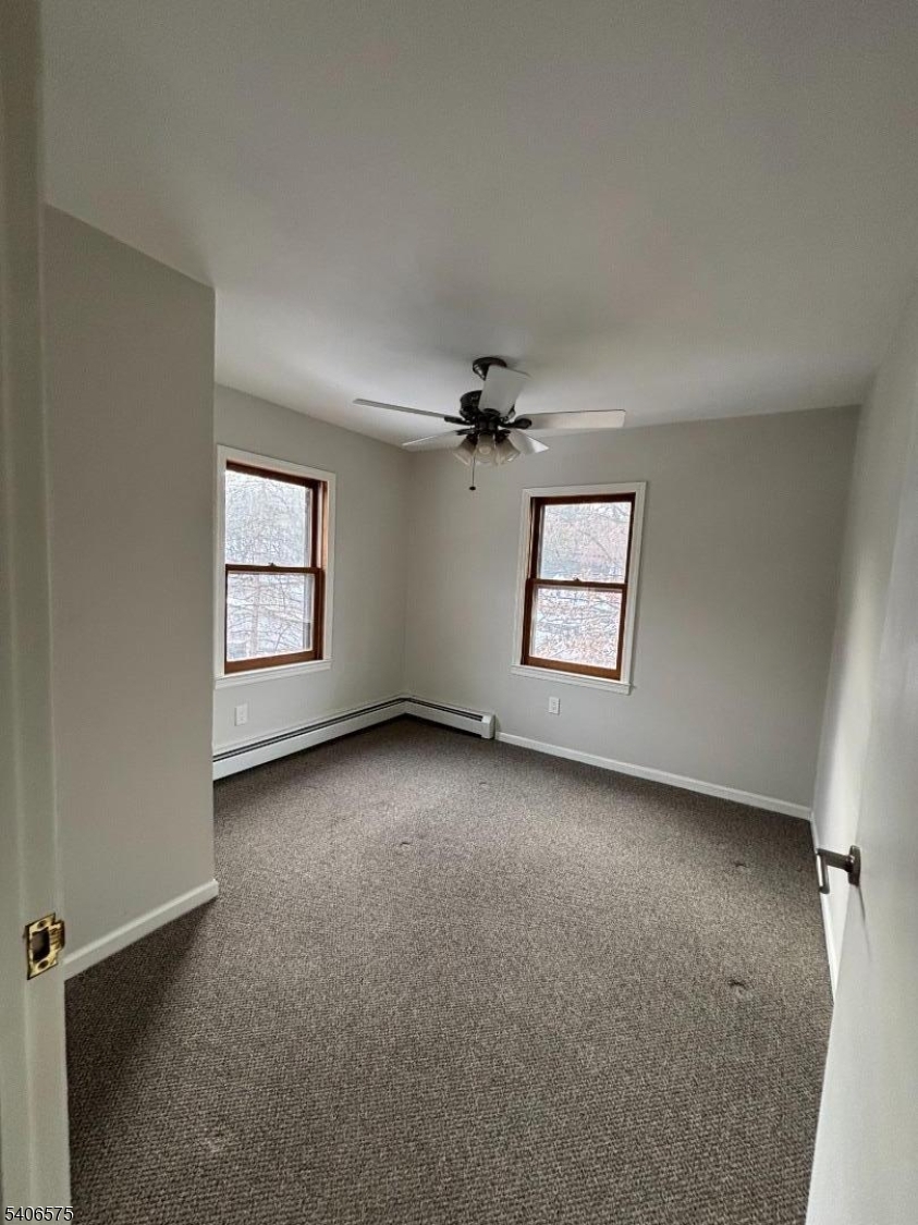 225 East Northfield Road Livingston, NJ 07039 - Photo 8 of 11 an empty room with windows and ceiling fan