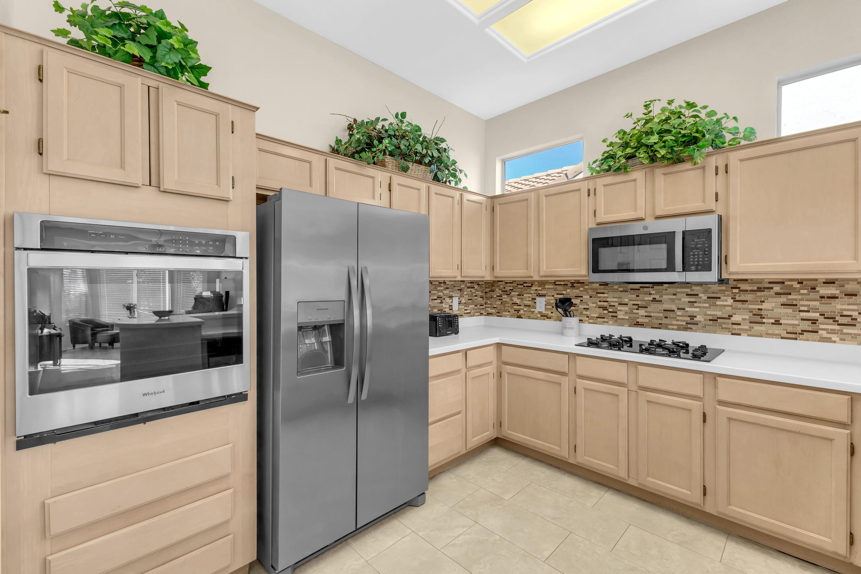 37468 Westridge Avenue Palm Desert, CA 92211 - Photo 16 of 40 a kitchen with white cabinets and stainless steel appliances