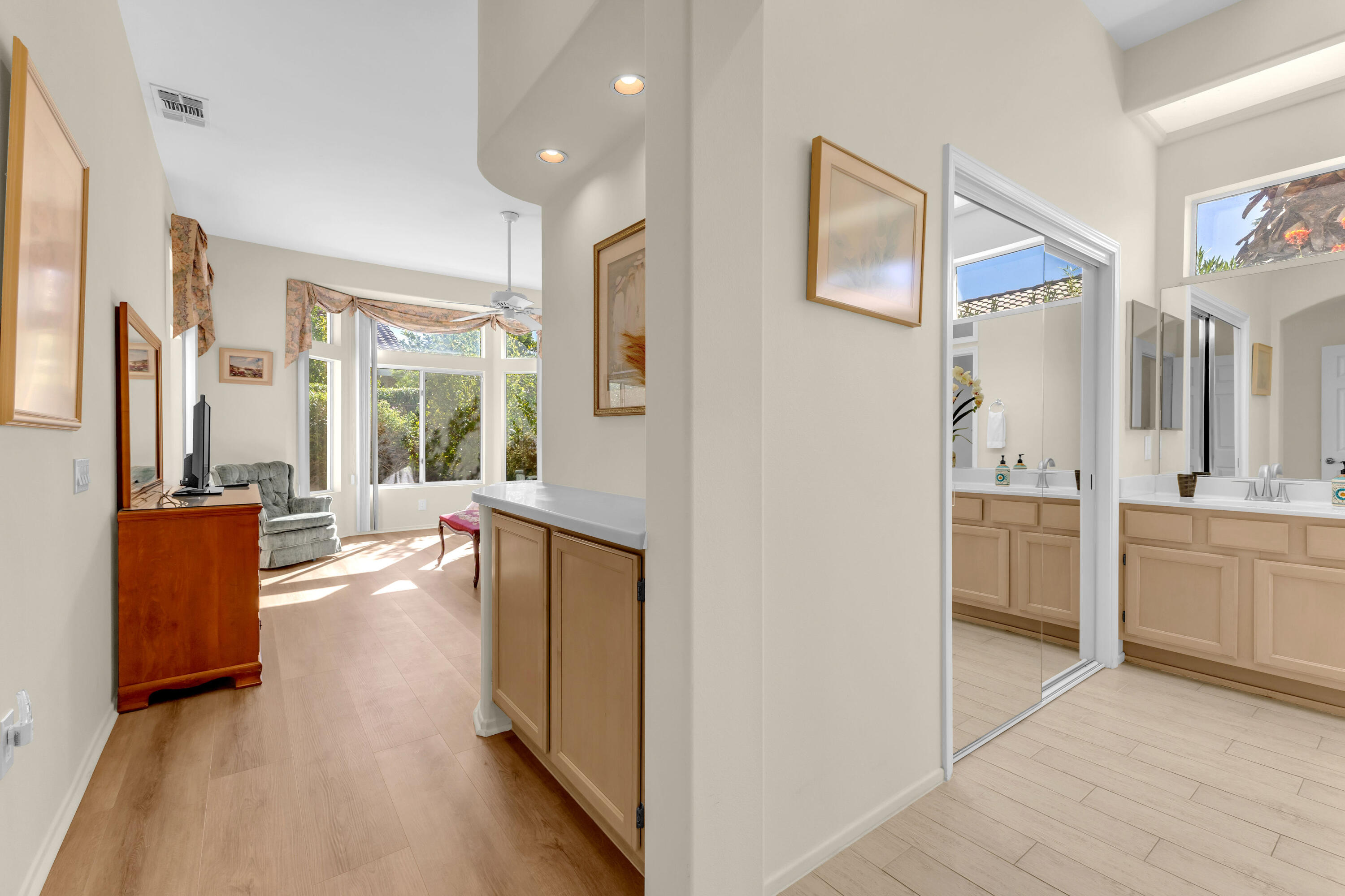 37468 Westridge Avenue Palm Desert, CA 92211 - Photo 19 of 40 a view of a hallway with wooden floor and a living room