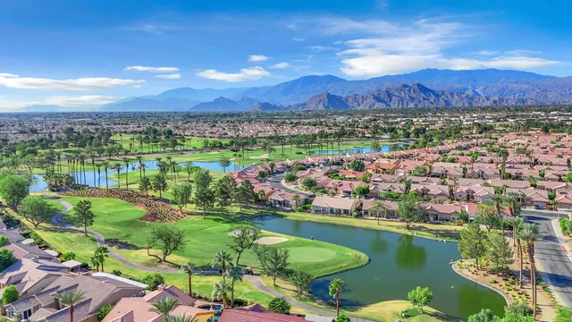 an aerial view of residential houses with outdoor space and street view