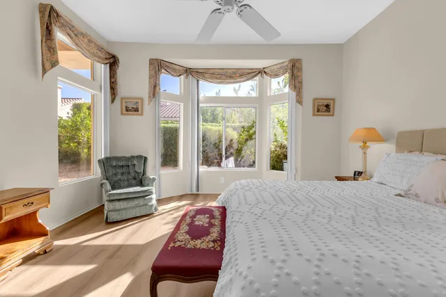 a view of a chairs with table and chairs under an umbrella