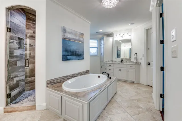 a spacious bathroom with a bathtub sink and mirror