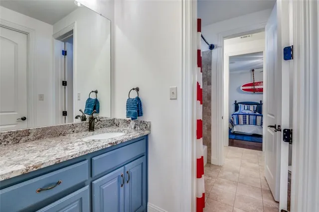 a bathroom with a sink vanity and mirror