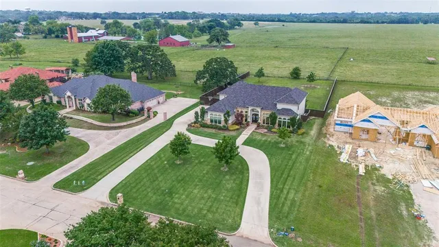 an aerial view of a house with outdoor space lake view