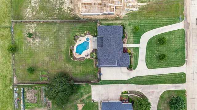 an aerial view of a house with outdoor space pool seating area and yard