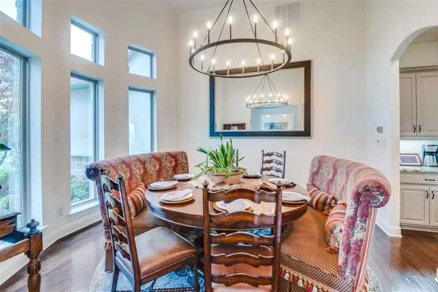 a view of a dining room with furniture wooden floor and chandelier