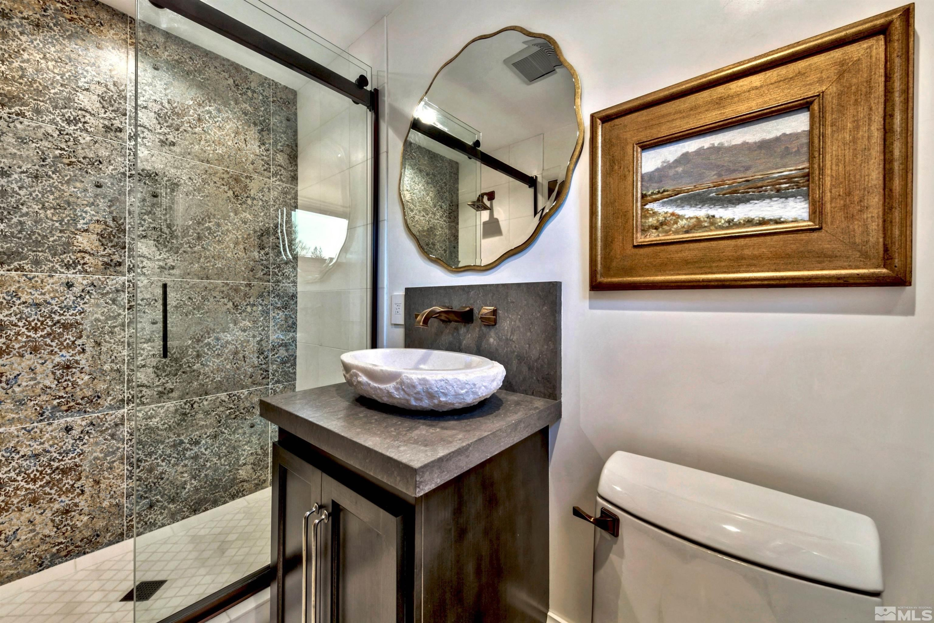 340 Ute Way Stateline, NV 89449 - Photo 25 of 40 a bathroom with a toilet a sink and a mirror