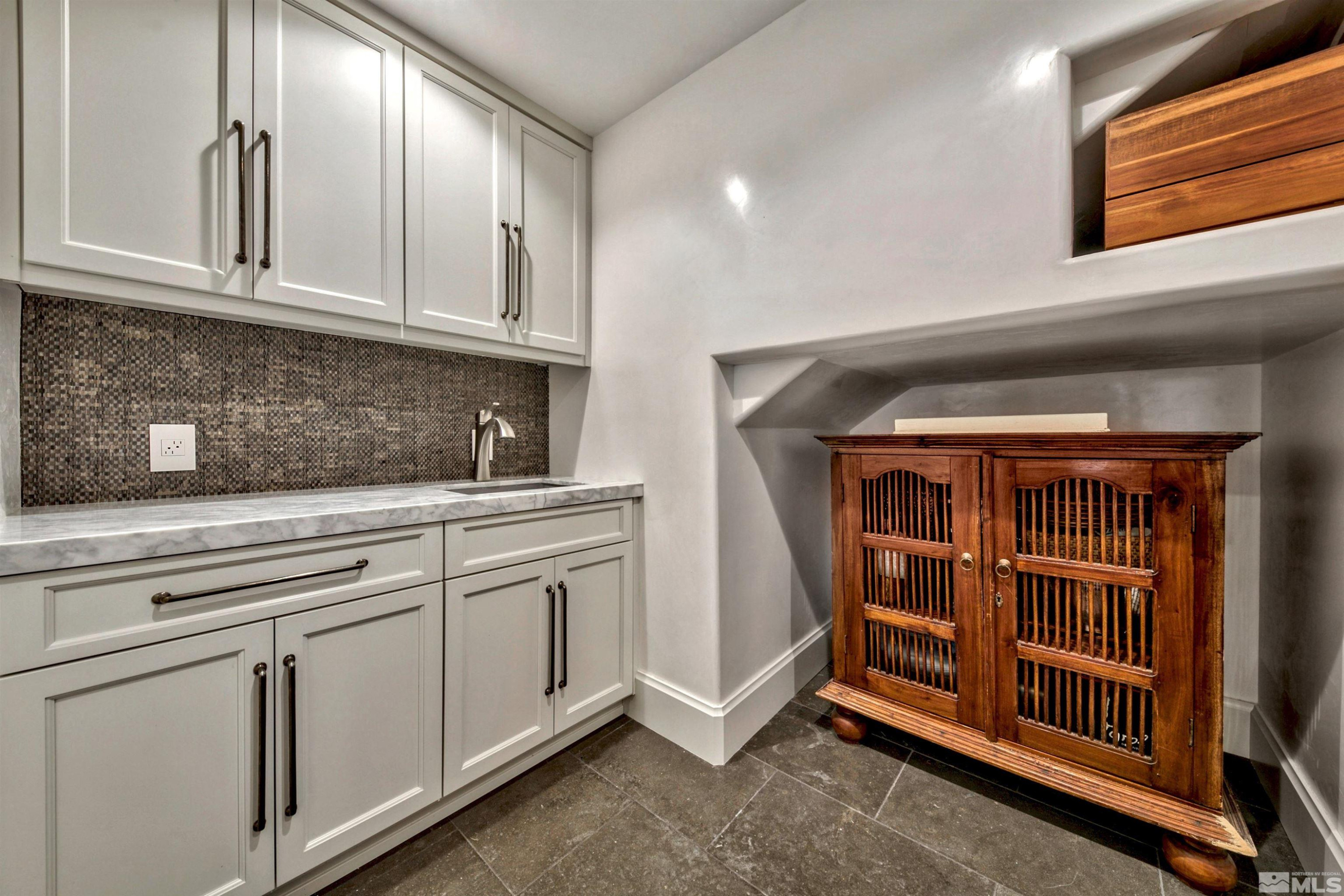 340 Ute Way Stateline, NV 89449 - Photo 27 of 40 a kitchen with stainless steel appliances granite countertop a cabinets and a stove top oven