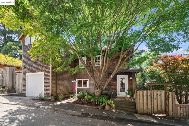 front view of a house with a tree