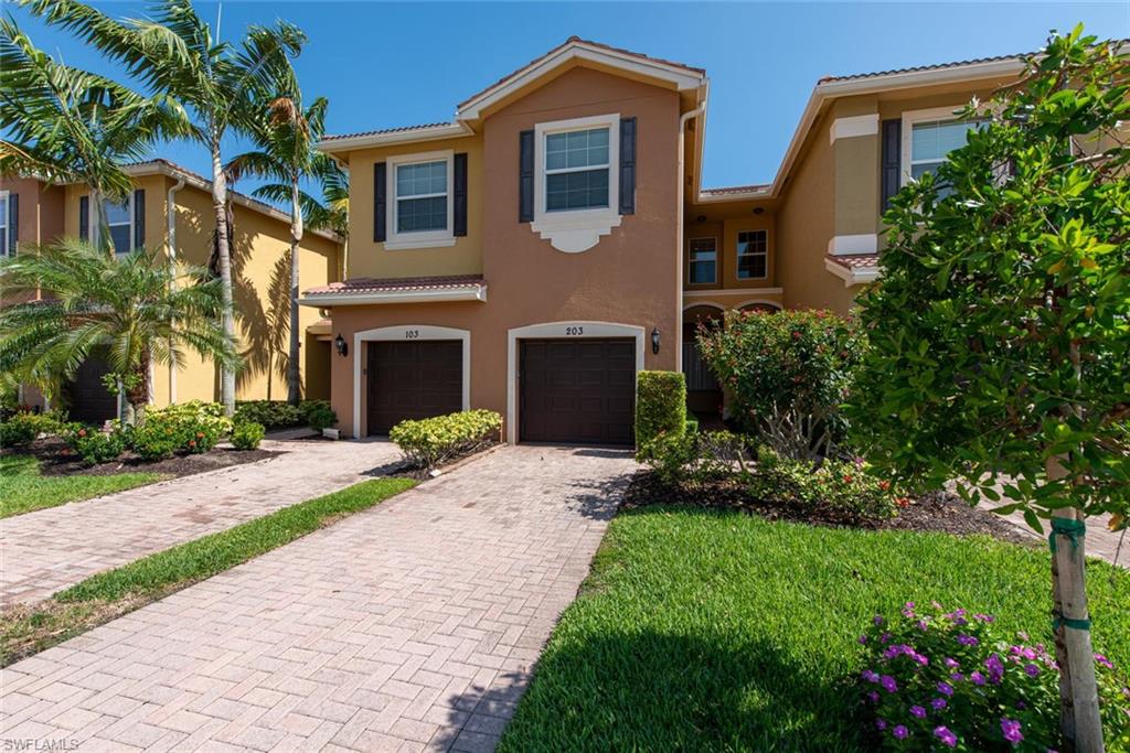 6521 Monterey Point, Unit 203 Naples, FL 34105 - Photo 1 of 17 a front view of a house with a garden and yard