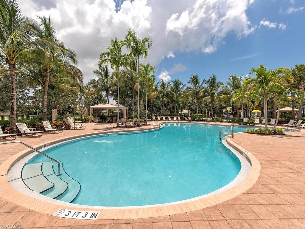 6521 Monterey Point, Unit 203 Naples, FL 34105 - Photo 13 of 17 a view of a swimming pool with outdoor seating