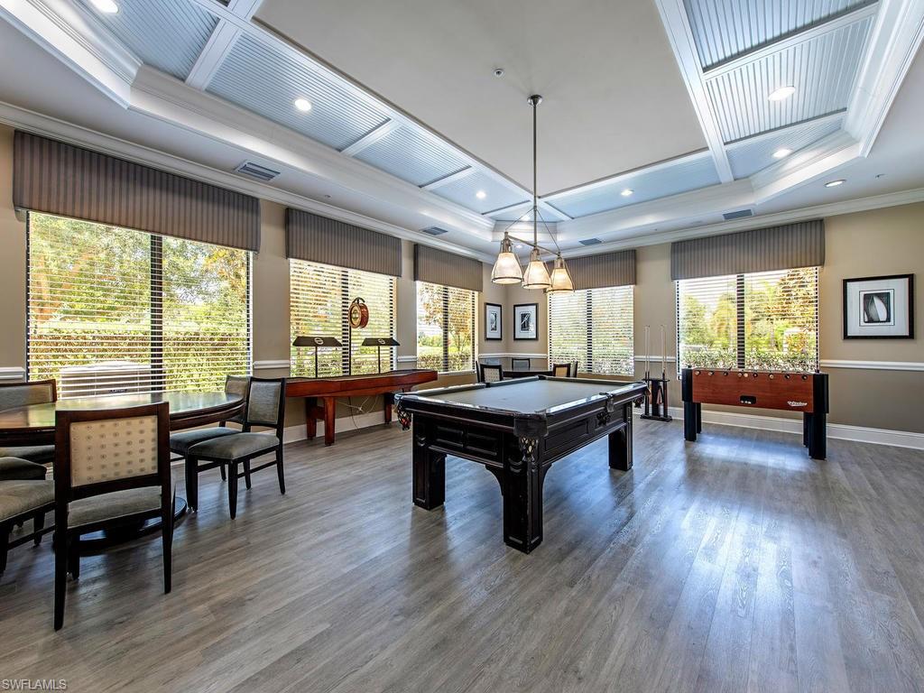 6521 Monterey Point, Unit 203 Naples, FL 34105 - Photo 15 of 17 a living room with furniture and a wooden floor