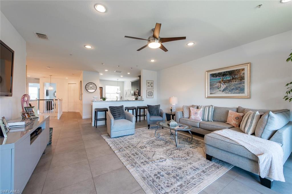 6521 Monterey Point, Unit 203 Naples, FL 34105 - Photo 6 of 17 a living room with furniture and kitchen view