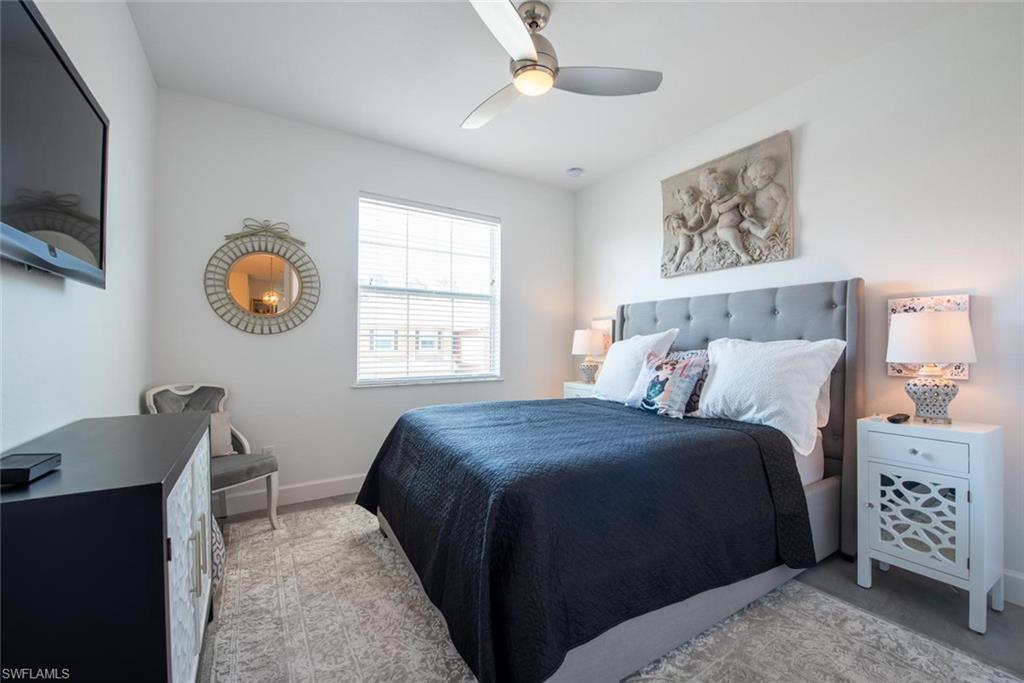 6521 Monterey Point, Unit 203 Naples, FL 34105 - Photo 10 of 17 a bedroom with a bed and a television