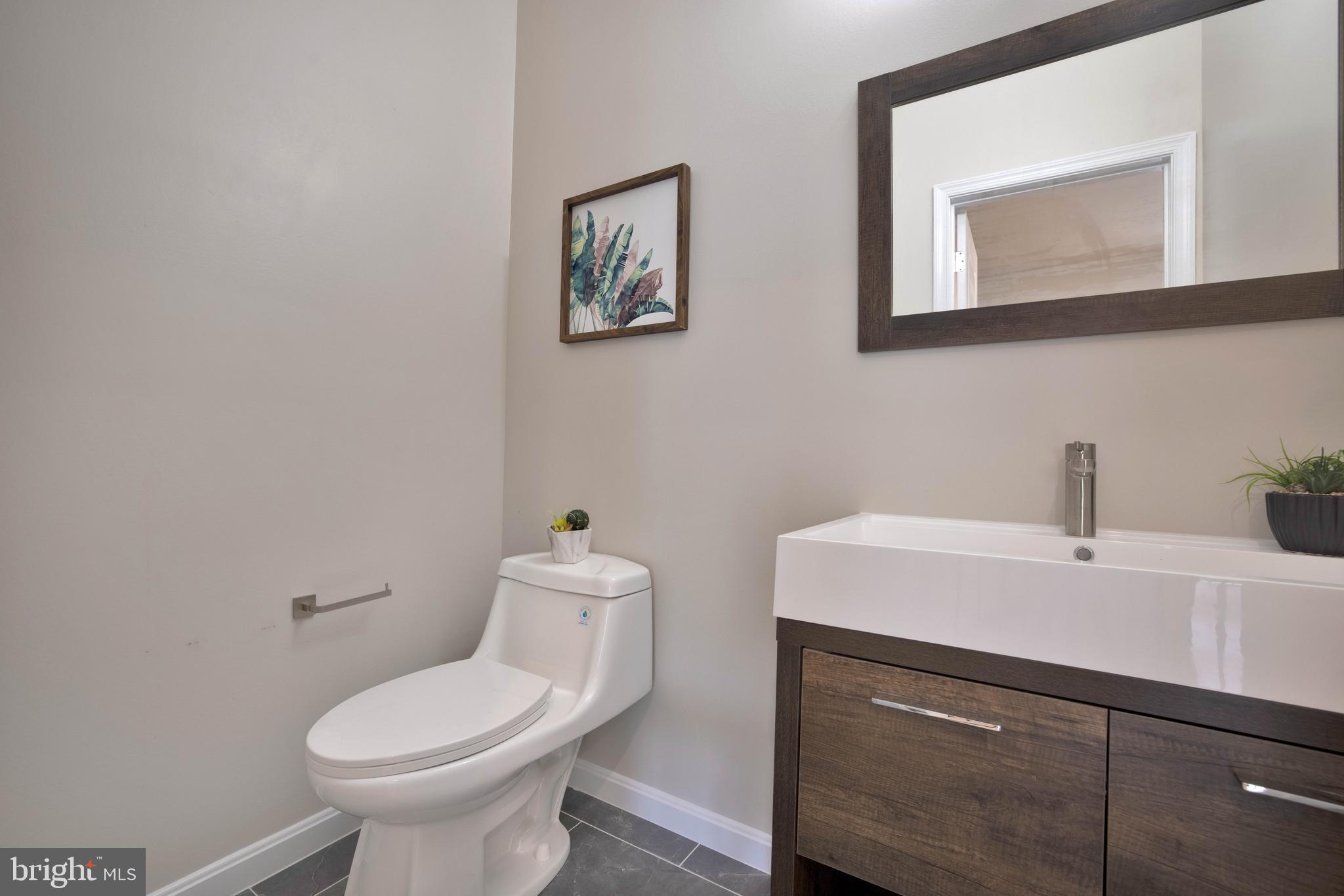 2417 Elvans Road Southeast Washington, DC 20020 - Photo 15 of 48 a bathroom with a toilet sink and mirror