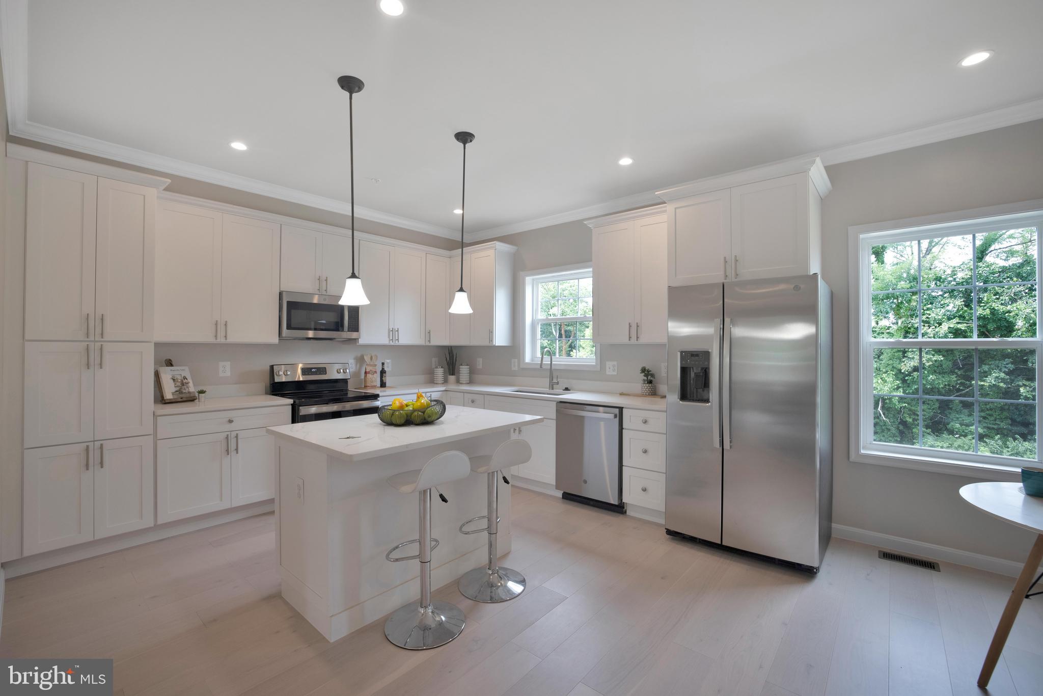 2417 Elvans Road Southeast Washington, DC 20020 - Photo 24 of 48 a kitchen with white cabinets stainless steel appliances and window