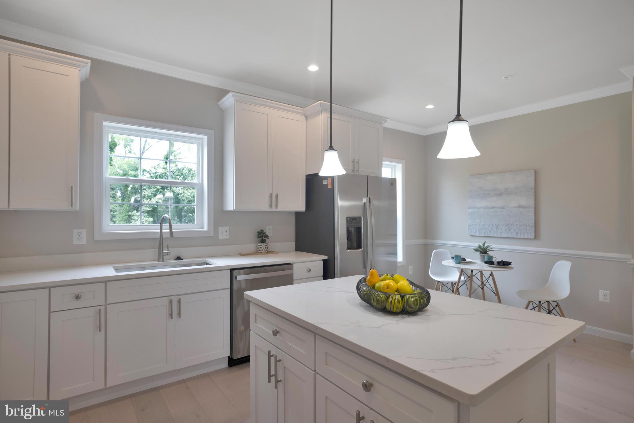 2417 Elvans Road Southeast Washington, DC 20020 - Photo 28 of 48 a kitchen with white cabinets and center island