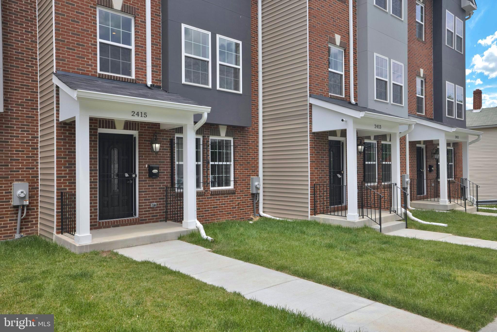 2417 Elvans Road Southeast Washington, DC 20020 - Photo 3 of 48 a view of a brick house with a yard