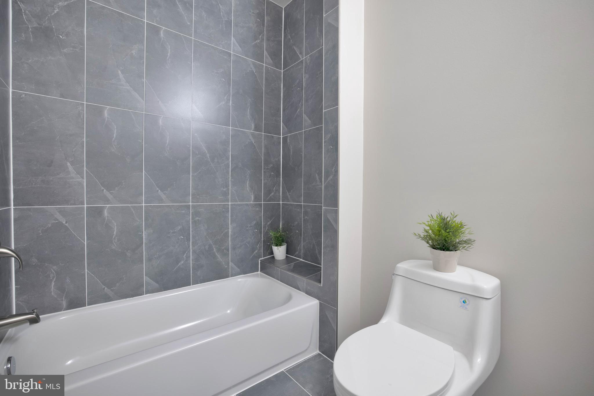 2417 Elvans Road Southeast Washington, DC 20020 - Photo 35 of 48 a white toilet and tub sitting next to a bathroom sink