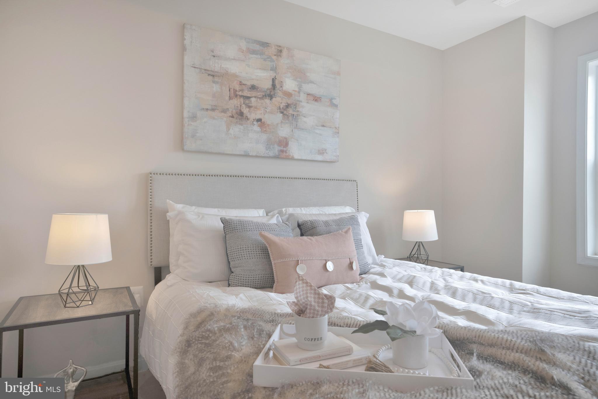 2417 Elvans Road Southeast Washington, DC 20020 - Photo 39 of 48 a bedroom with a bed and a lamp on table