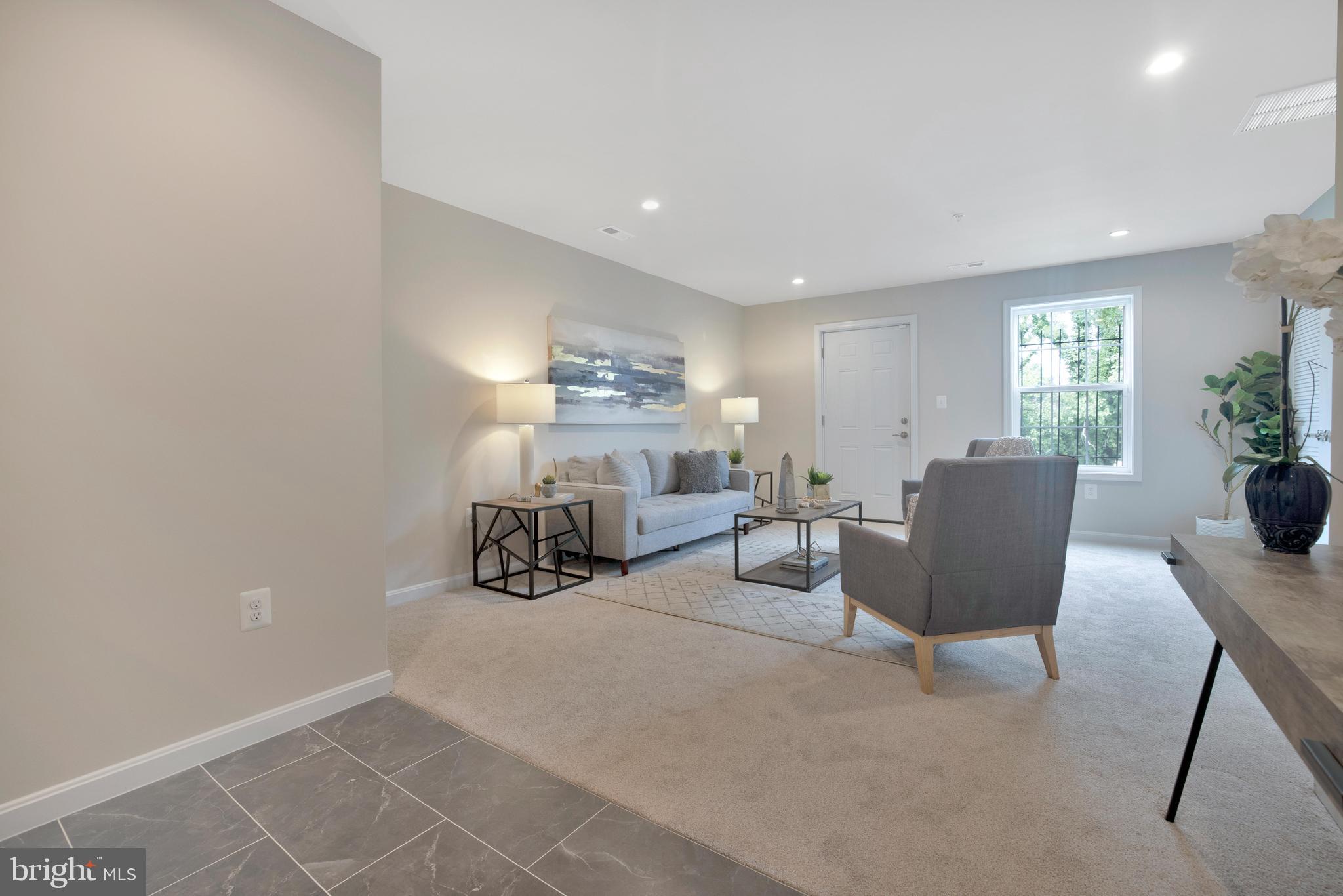 2417 Elvans Road Southeast Washington, DC 20020 - Photo 5 of 48 a bedroom with furniture and a potted plant