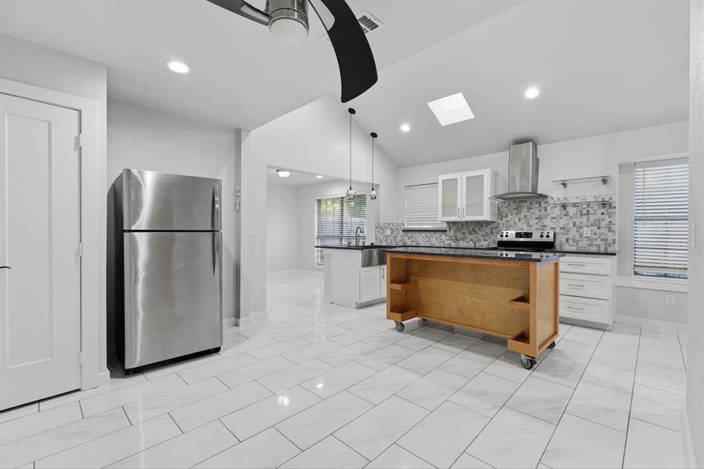 3721 Smartt Street Rowlett, TX 75088 - Photo 18 of 27 a kitchen with stainless steel appliances granite countertop a refrigerator a stove a sink and a refrigerator