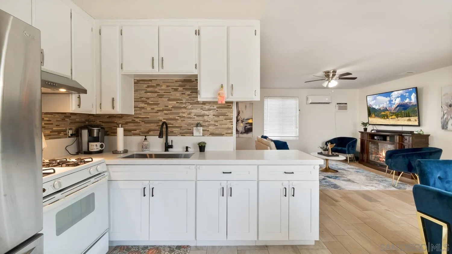 445 Kempton Street Spring Valley, CA 91977 - Photo 8 of 56 a kitchen with stainless steel appliances a sink stove and cabinets