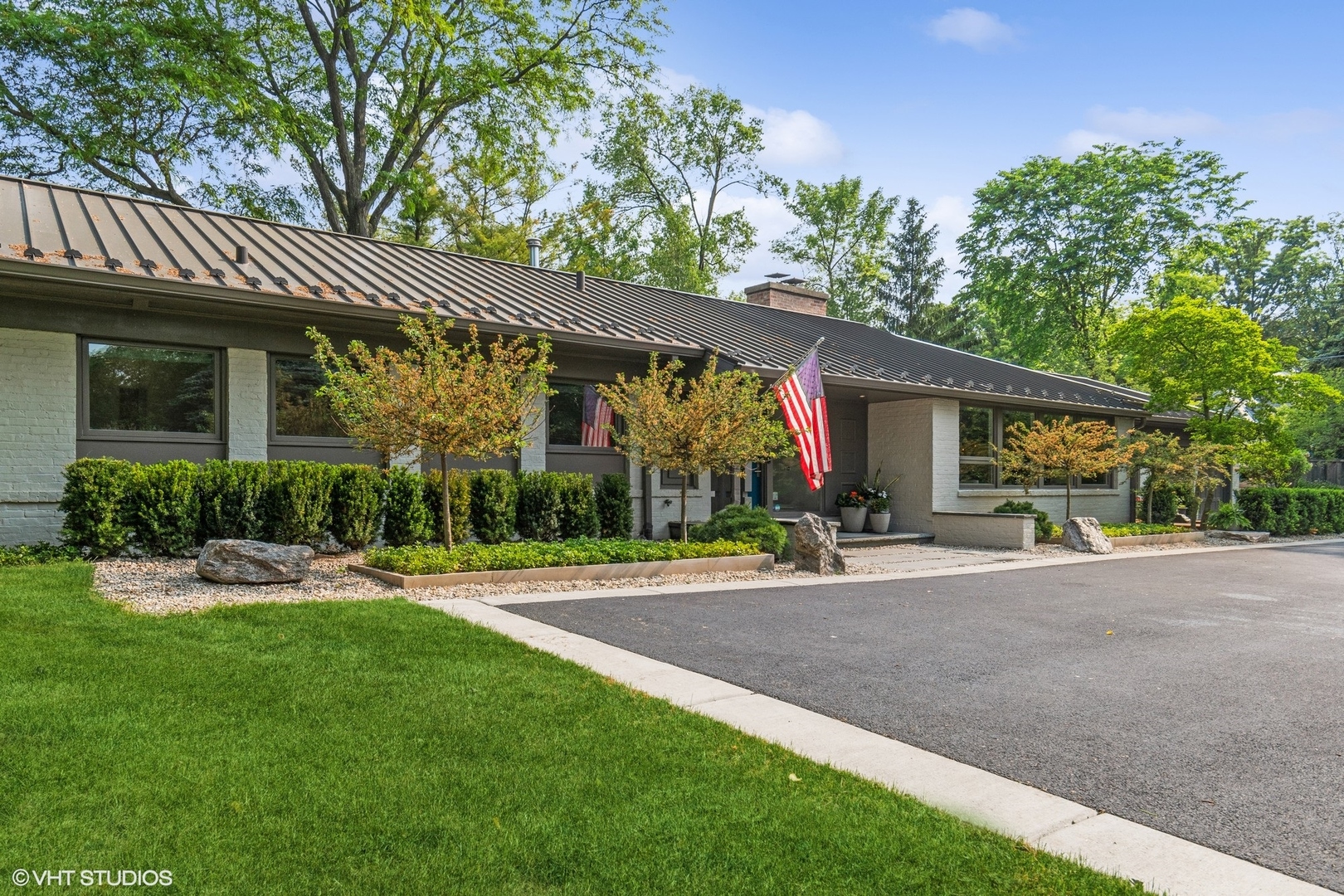 a view of a house with a yard and sitting area