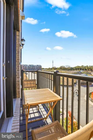 a view of a balcony with wooden chairs