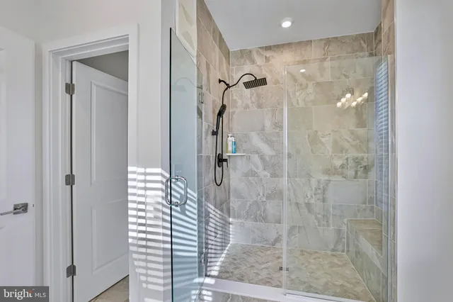 a bathroom with a glass shower door