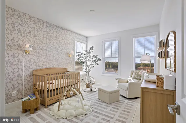 a living room with furniture a rug and a table