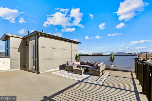 a roof deck with a table and chairs