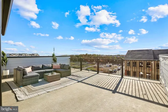 a view of a terrace with couches and sky view
