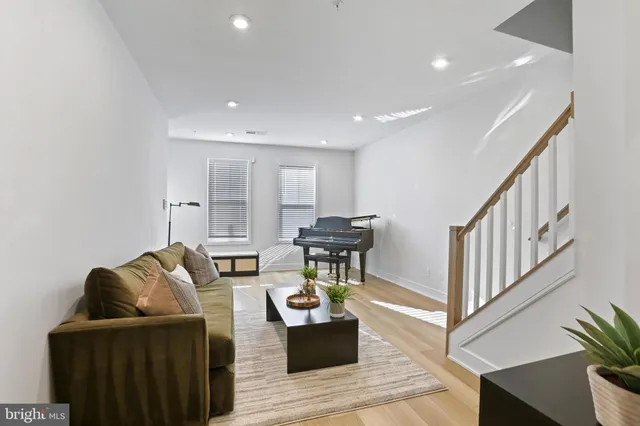 a living room with furniture and wooden floor
