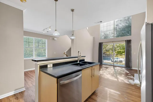 a kitchen that has a sink a window and a table in it