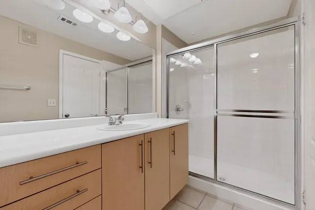 a bathroom with a sink a mirror and a light fixture