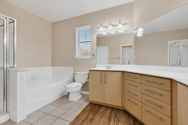 a bathroom with a double vanity sink mirror and toilet