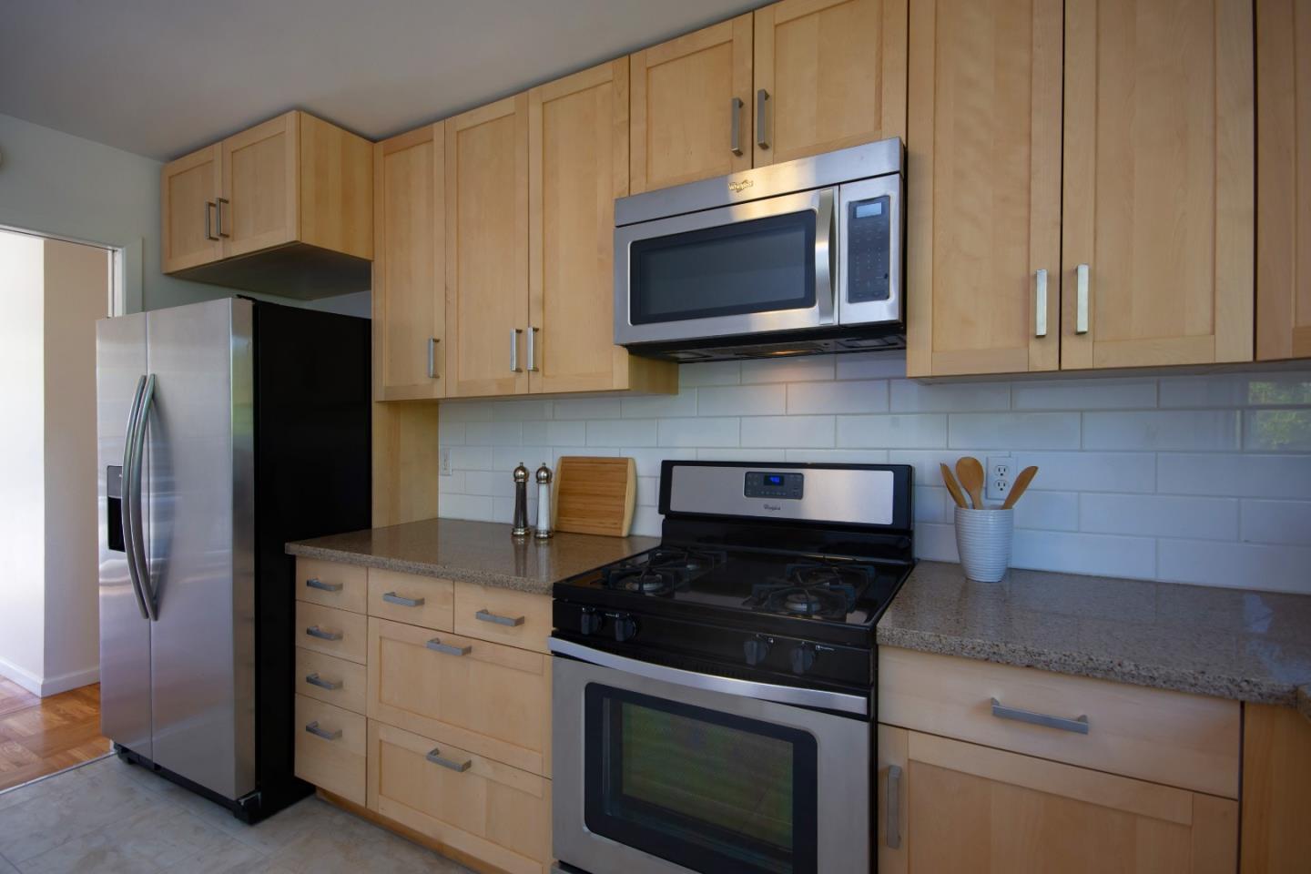 1179 Glenwood Drive Millbrae, CA 94030 - Photo 5 of 21 a kitchen with stainless steel appliances granite countertop white cabinets and a stove top oven