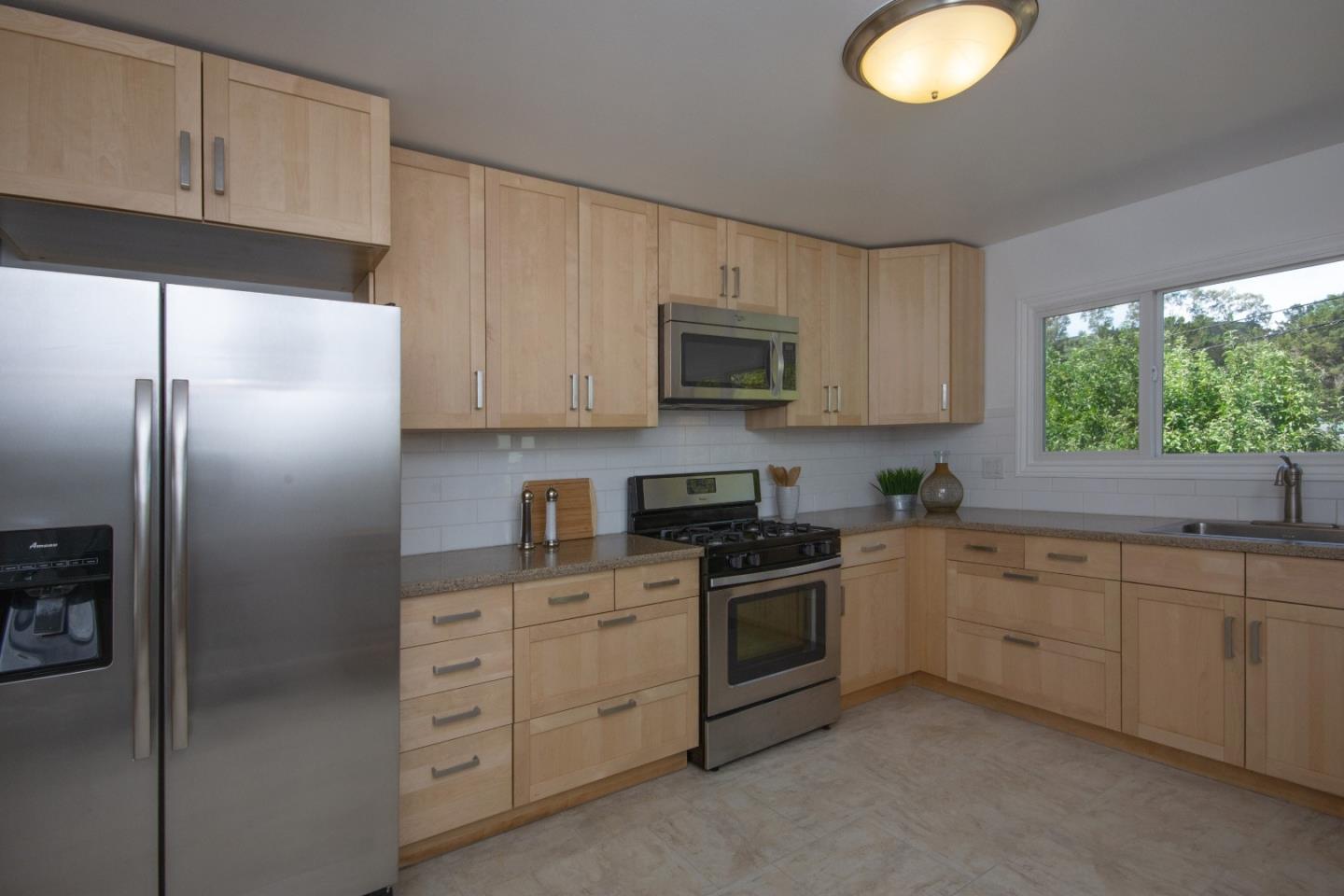 1179 Glenwood Drive Millbrae, CA 94030 - Photo 6 of 21 a kitchen with cabinets stainless steel appliances and window