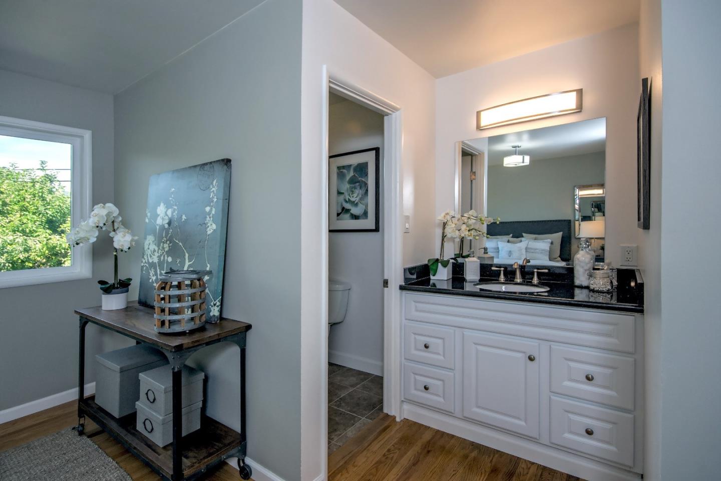 1179 Glenwood Drive Millbrae, CA 94030 - Photo 9 of 21 a kitchen with white cabinets and chandelier