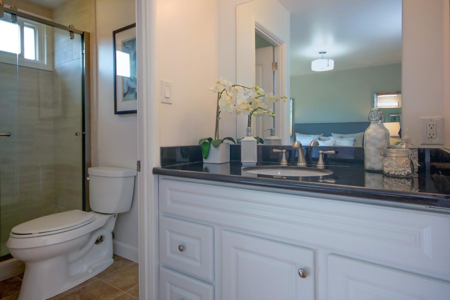 1179 Glenwood Drive Millbrae, CA 94030 - Photo 10 of 21 a bathroom with a toilet a sink and mirror