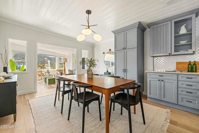 a bedroom with a bed and large windows