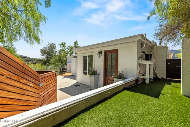a view of an house with backyard porch and furniture