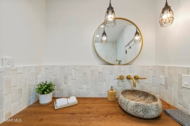 a view of a patio with couches table and chairs and potted plants
