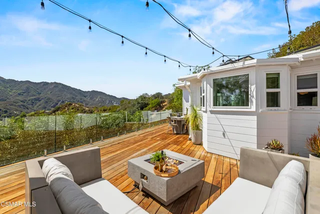 a view of balcony with wooden floor and fence and floor